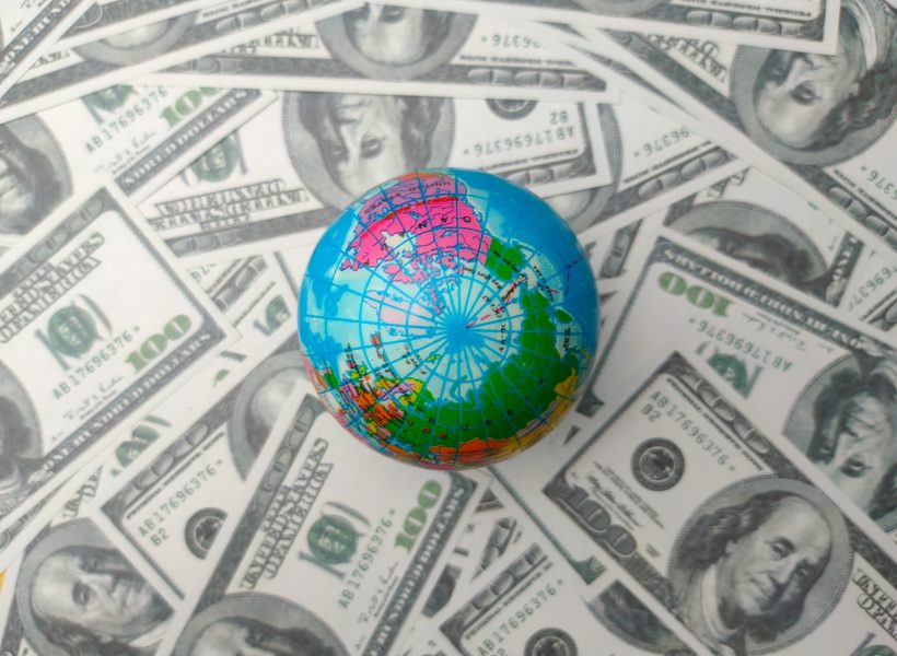 Top view earth globe on a dollar banknotes. Business concept
